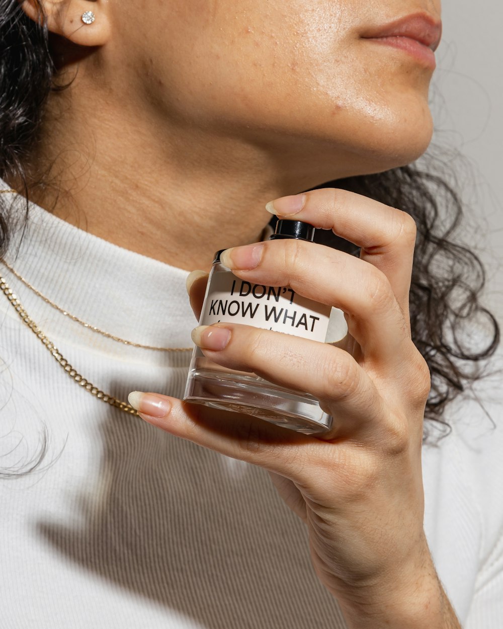 woman in white shirt holding black and white ceramic mug