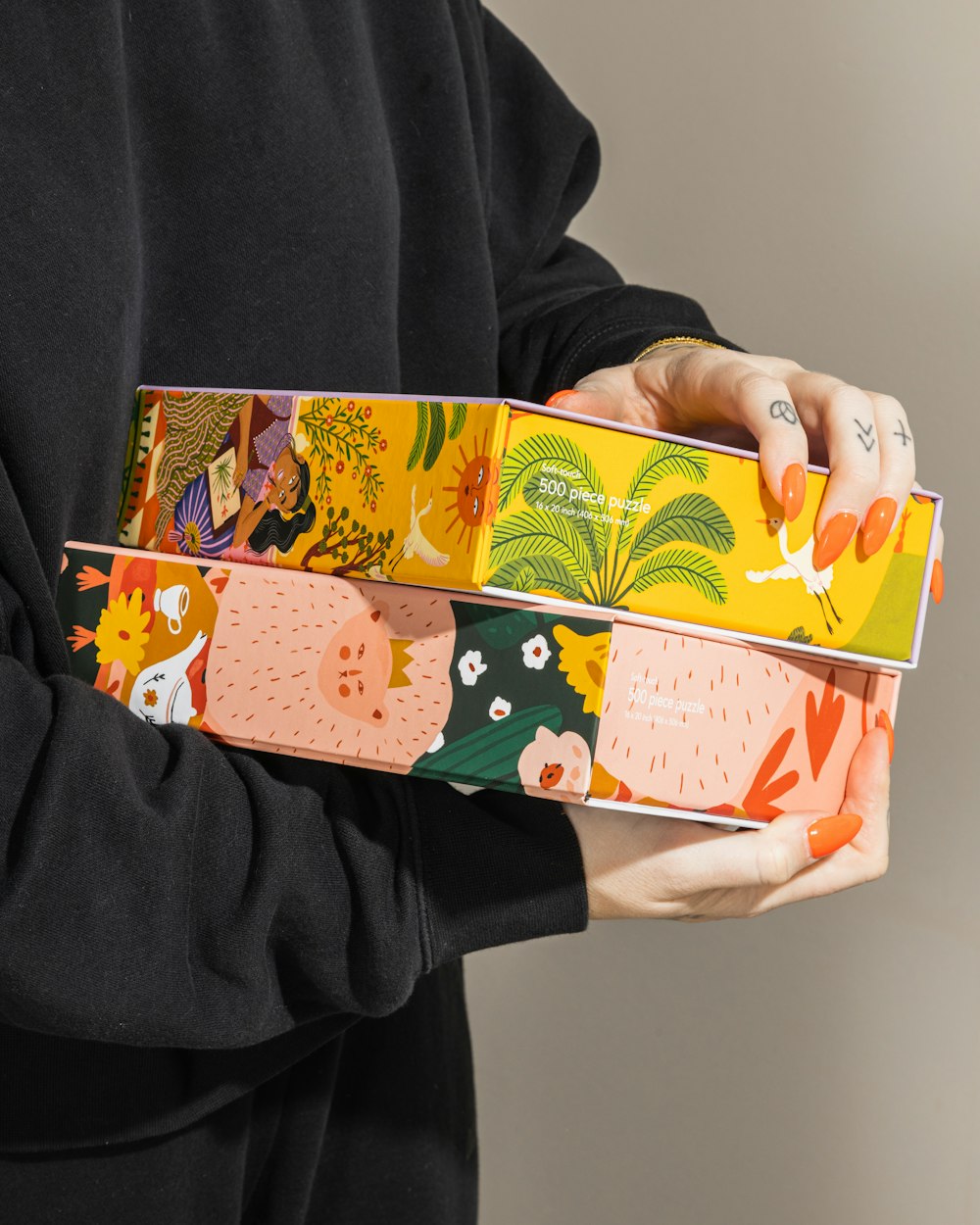 person holding white green and orange floral gift box