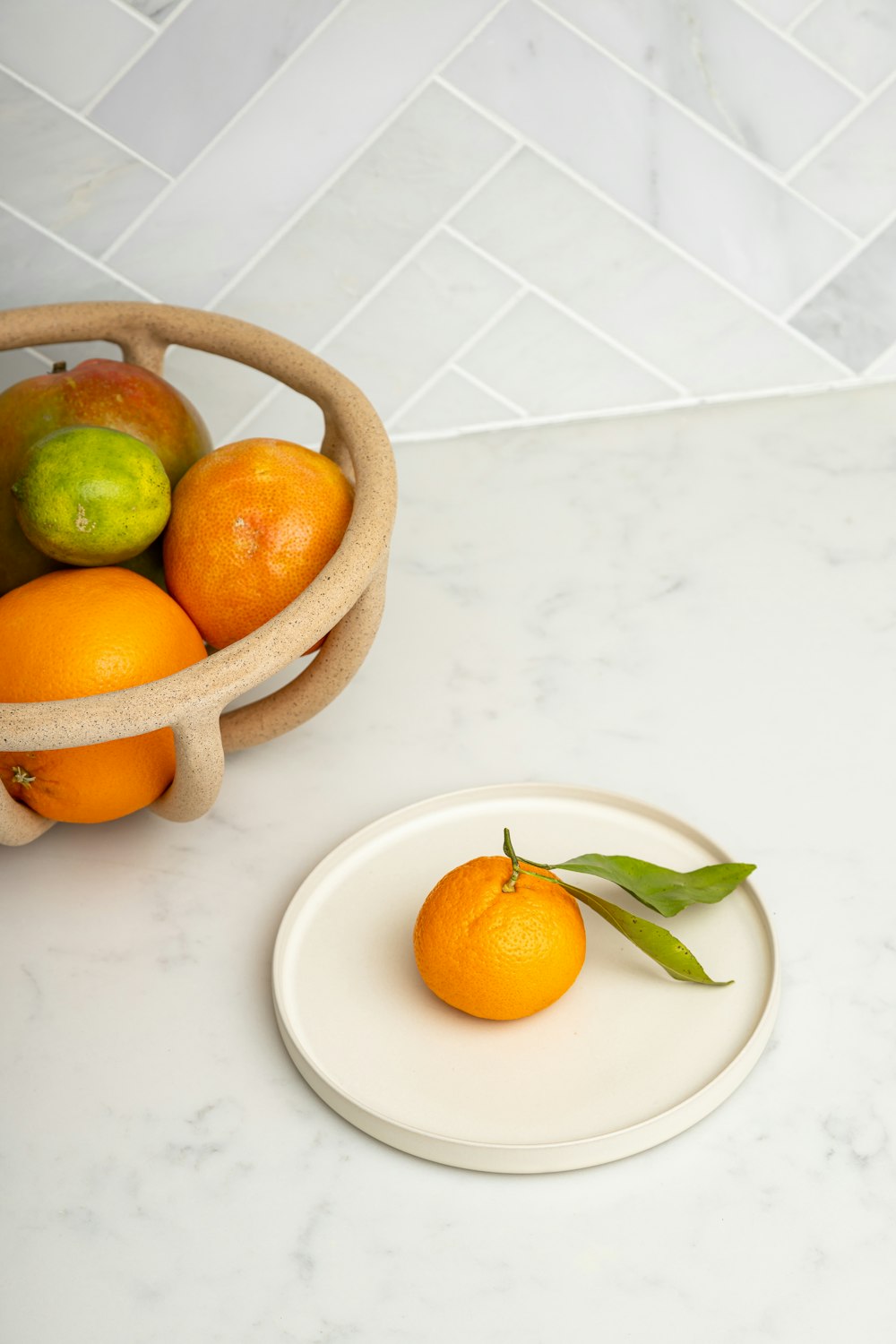 orange fruits on white ceramic bowl