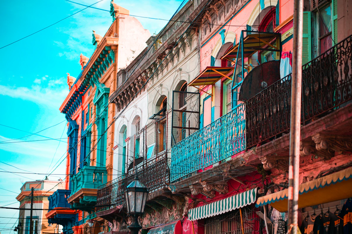 A vibrant street in Palermo, Buenos Aires at night with cafe lights and people dining outdoors