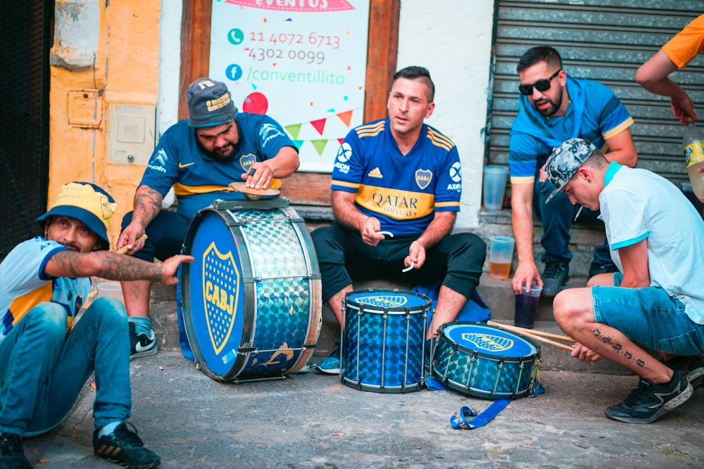 man in blue crew neck t-shirt playing drum