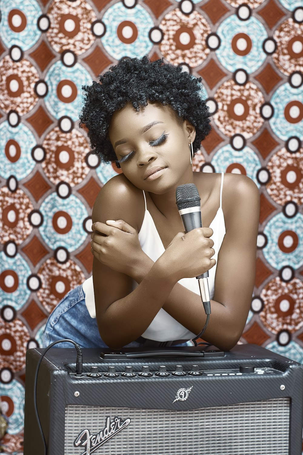 woman in blue denim jacket holding microphone