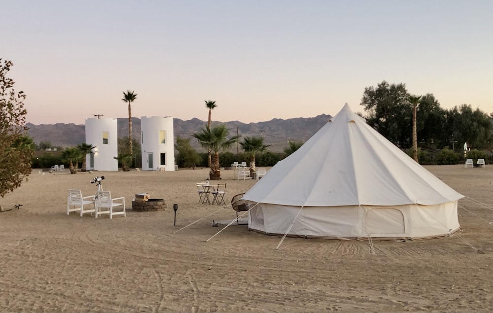 white tent on brown field during daytime