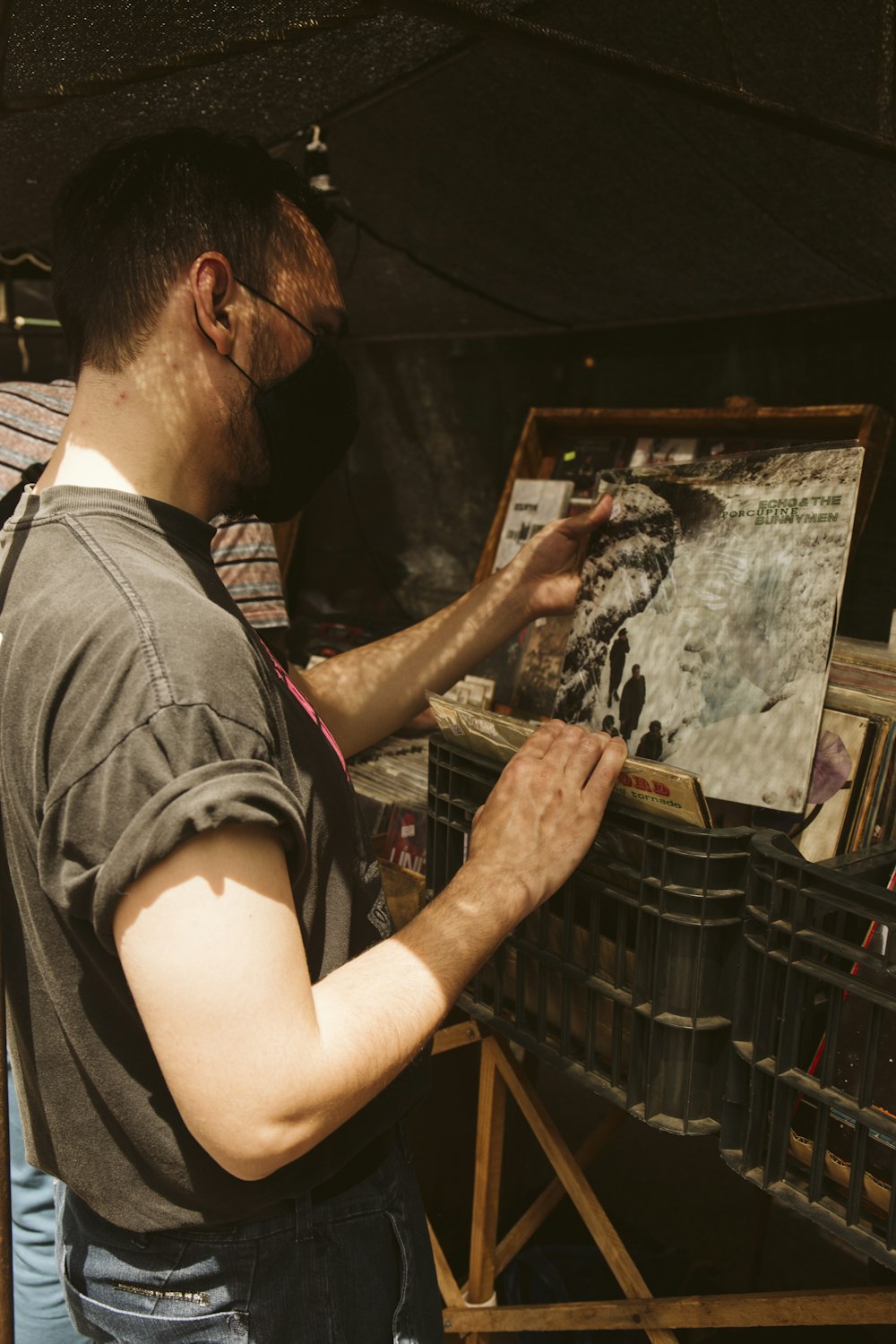 man in black crew neck t-shirt holding black and white painting