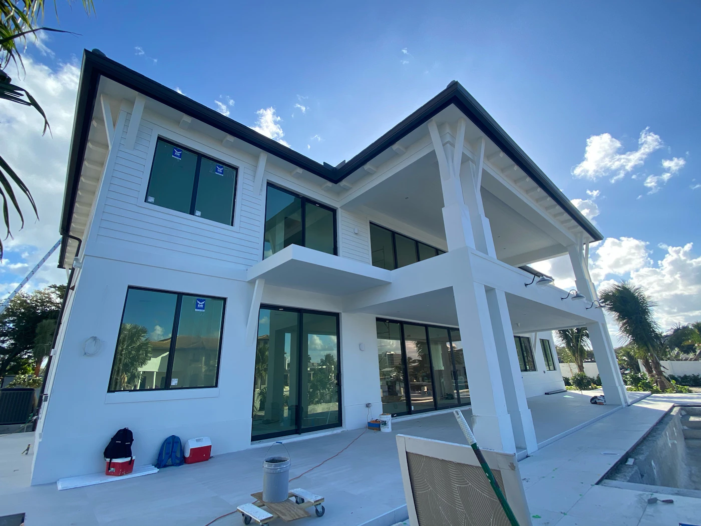 A newly built two-story white home under a blue sky