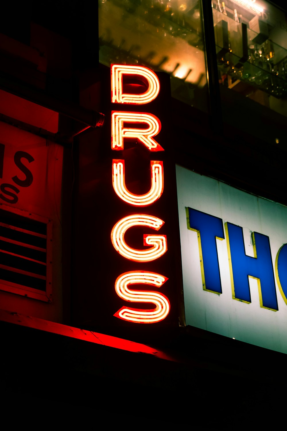 a lit up sign that says drugs and thor
