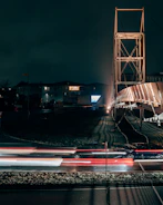 Nighttime shot of illuminated cable-stayed bridge with embedded AI monitoring systems.