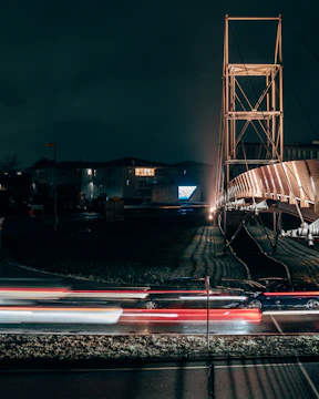 Nighttime shot of illuminated cable-stayed bridge with embedded AI monitoring systems.