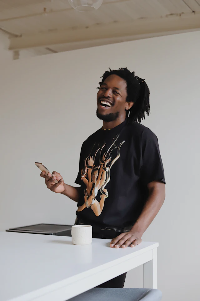 A man smiling in a casual everyday setting.