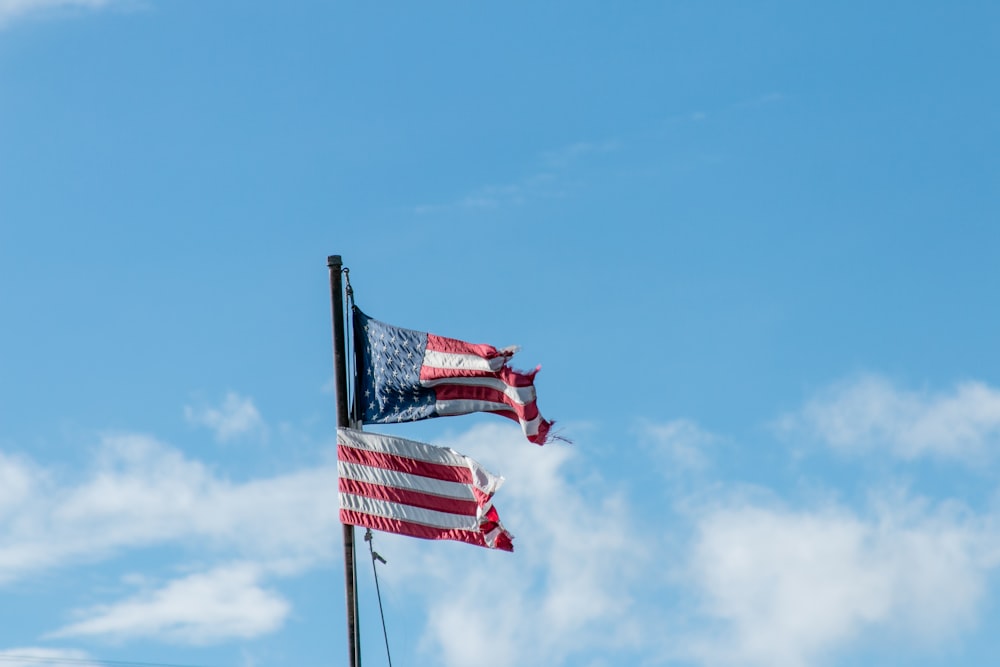 us a flag on pole under blue sky during daytime