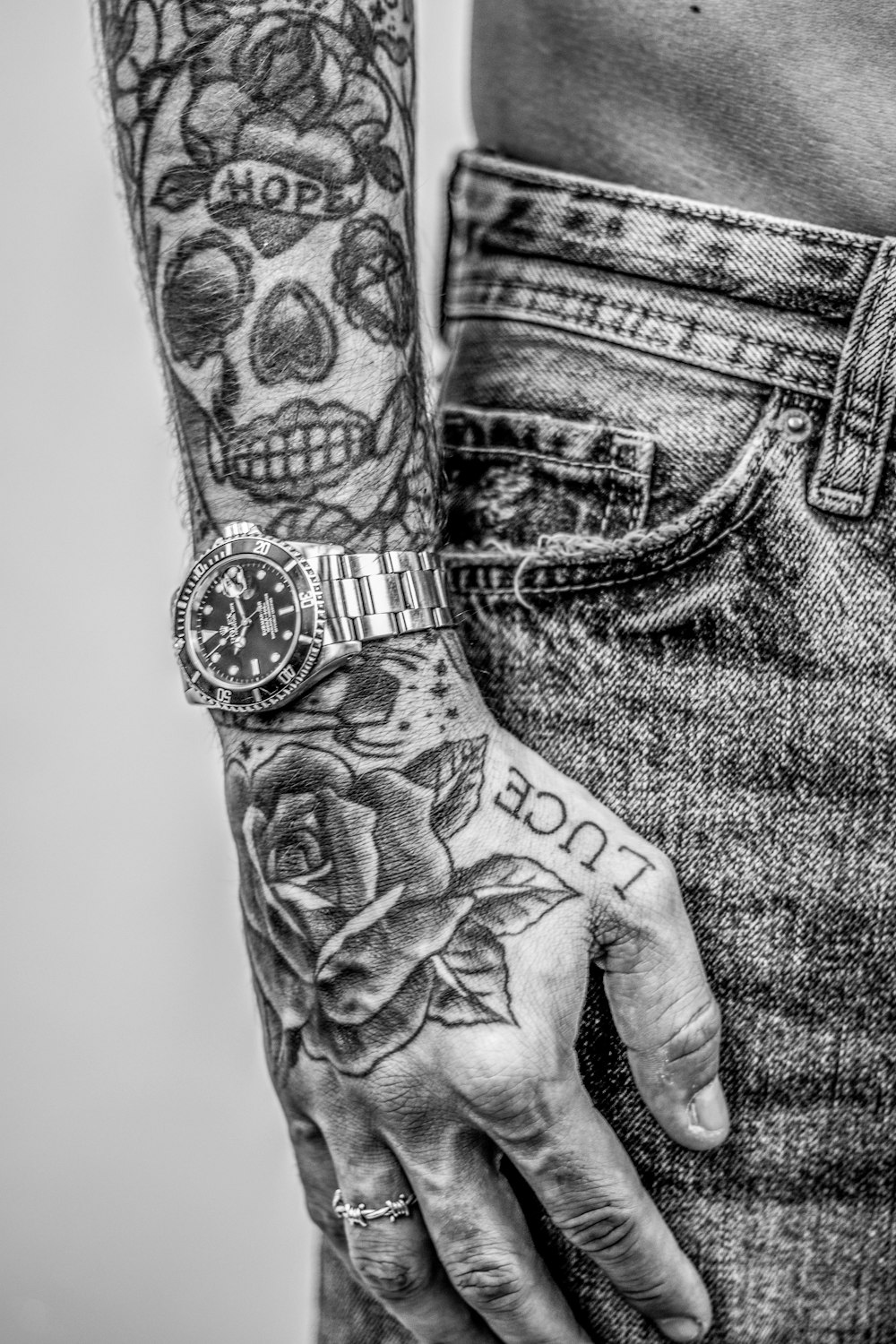 grayscale photo of person with tattoo on right arm