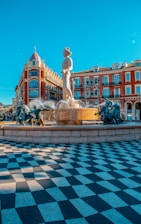 white statue in front of brown building during daytime