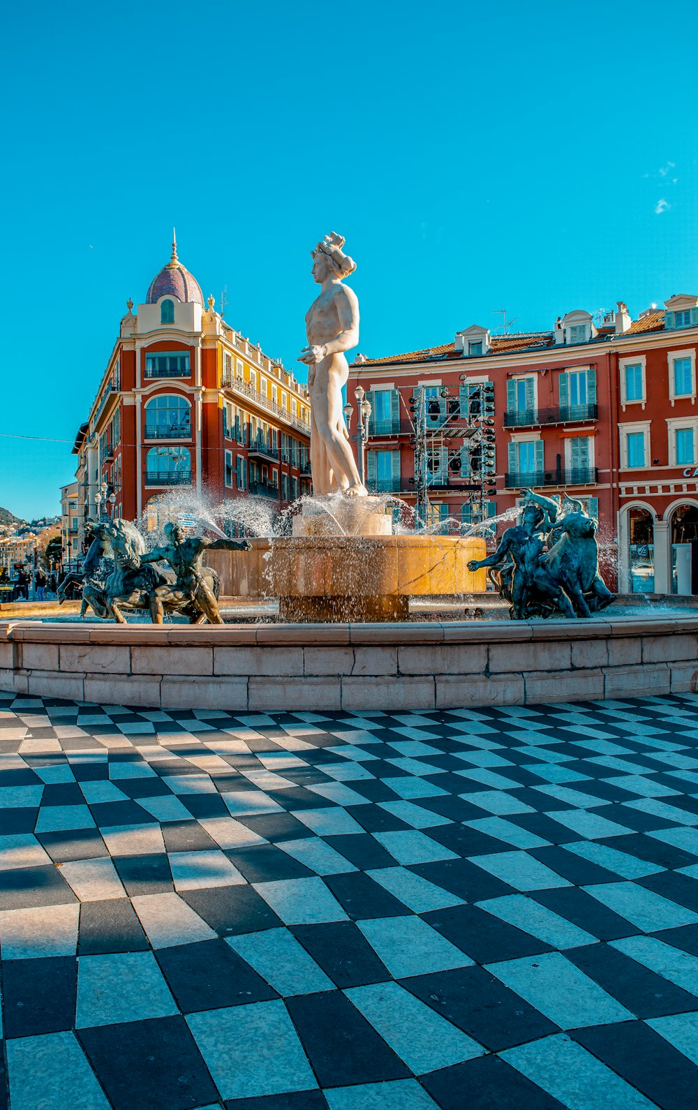 white statue in front of brown building during daytime