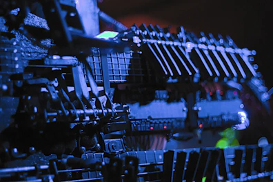 Power equipment components displayed with sharp focus and warm orange lighting.