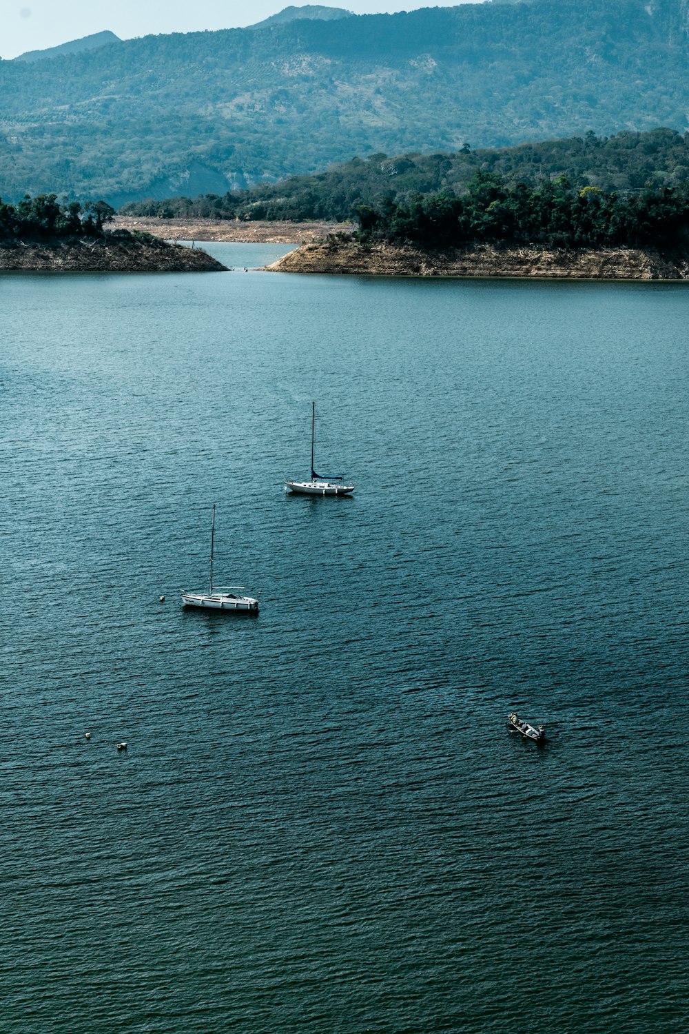 white boat on body of water during daytime