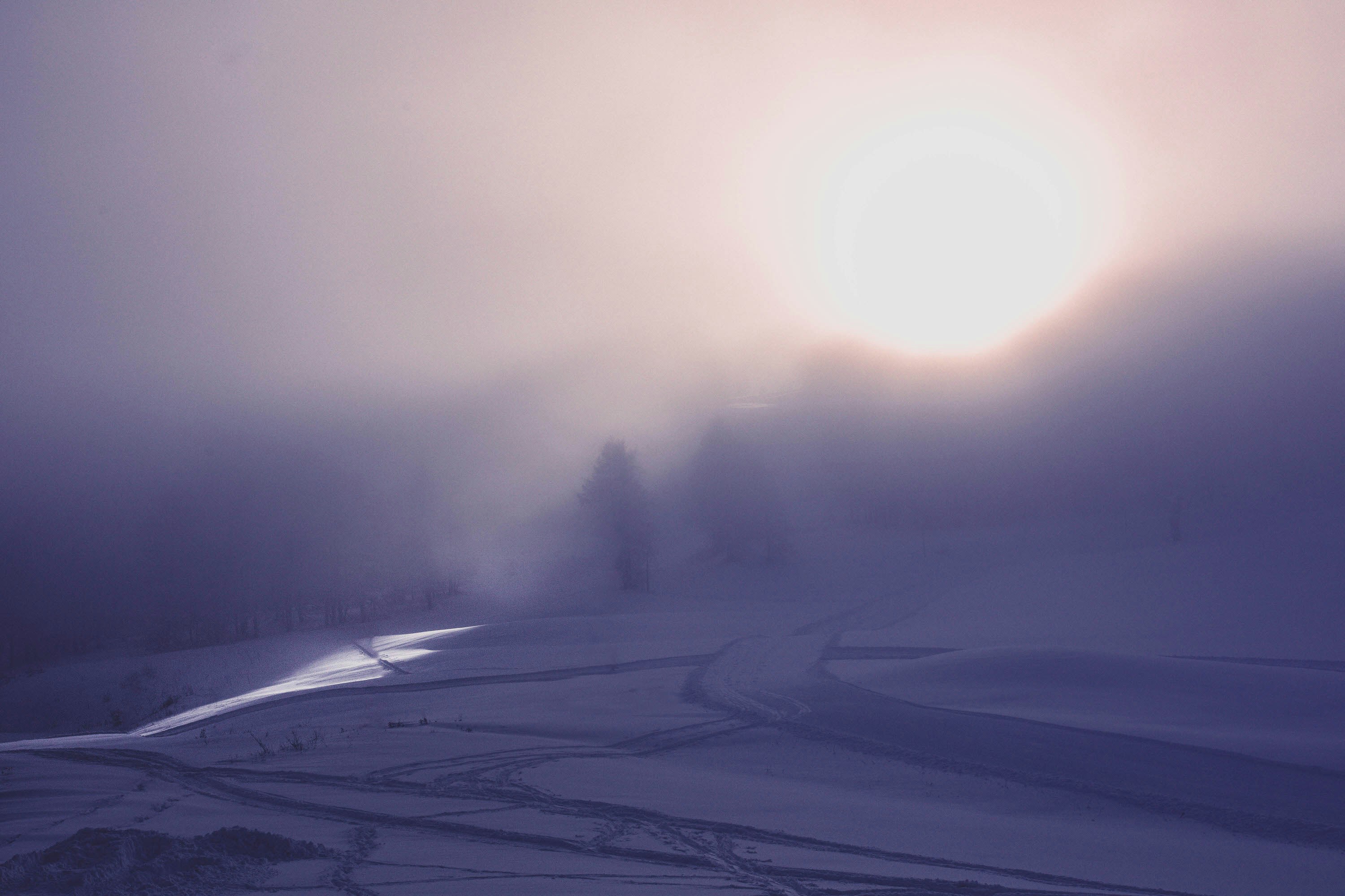 Weird alpine light creeps through the clouds onto the snowy floor of the ski resort of Montgenèvre.