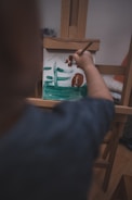 person holding brown wooden board