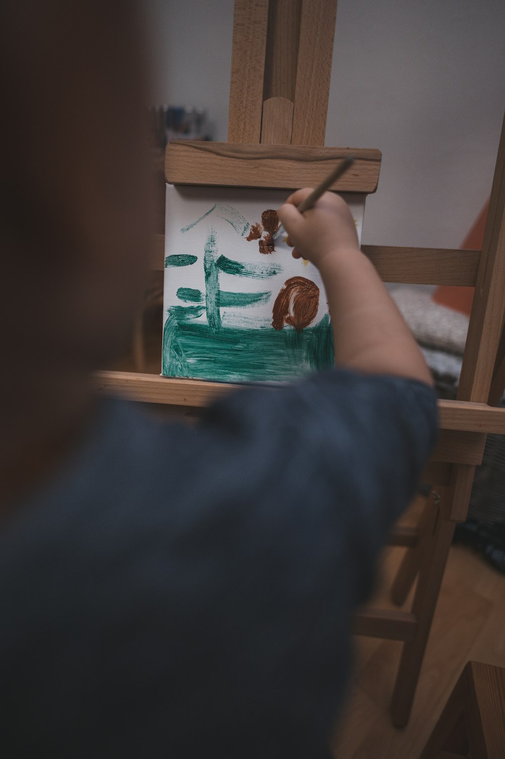 person holding brown wooden board