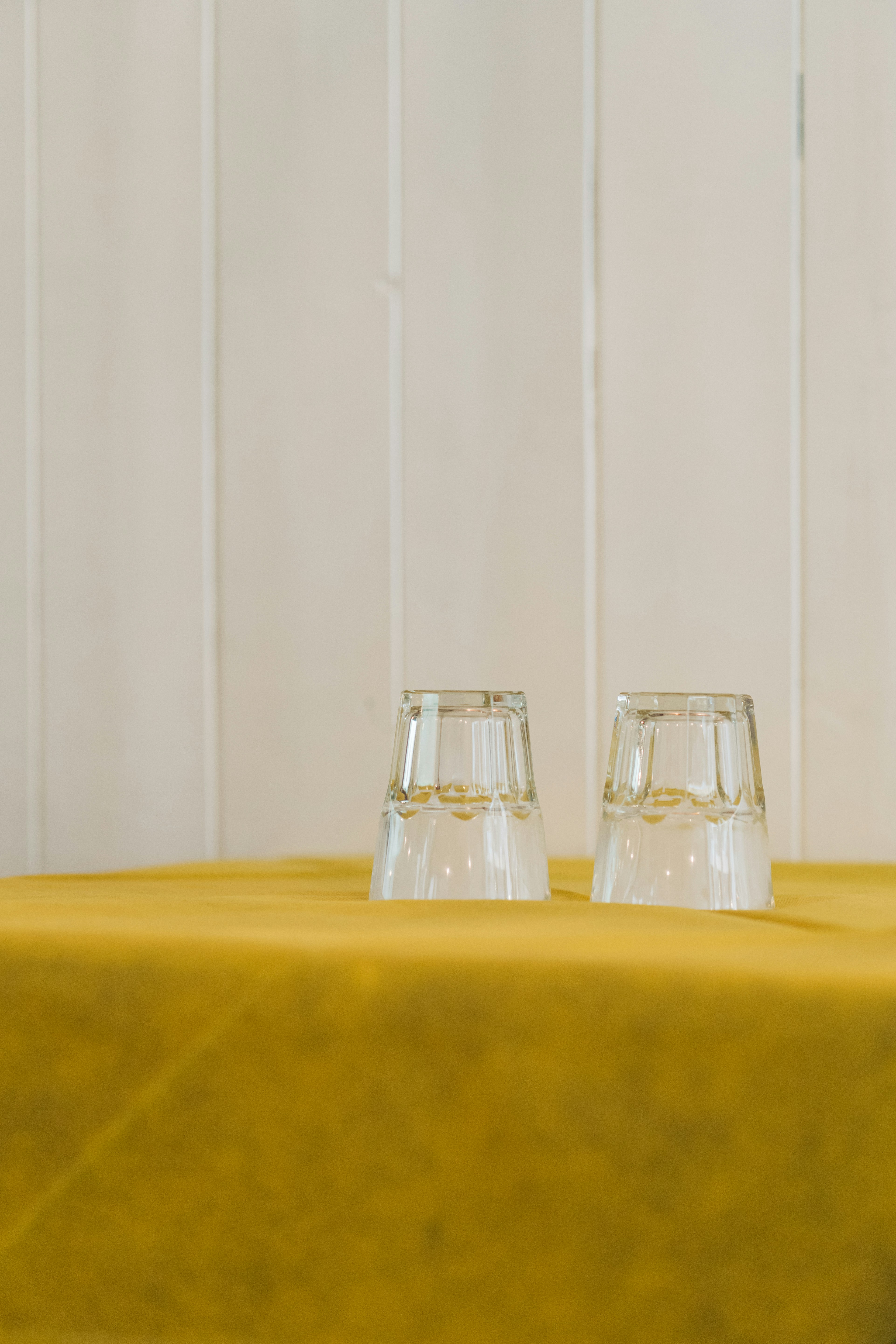 Two glasses on a yellow table cloth