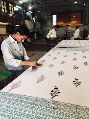 A detailed shot of hand block printing in progress on soft cotton fabric, highlighting traditional techniques.