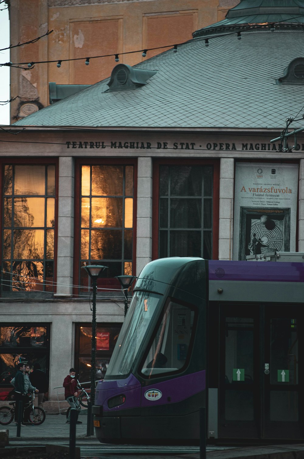 red and white train in front of brown building during daytime