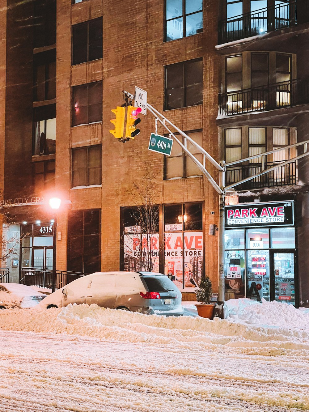 cars parked beside brown building during daytime