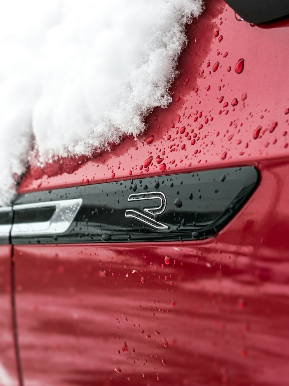 red car with white snow