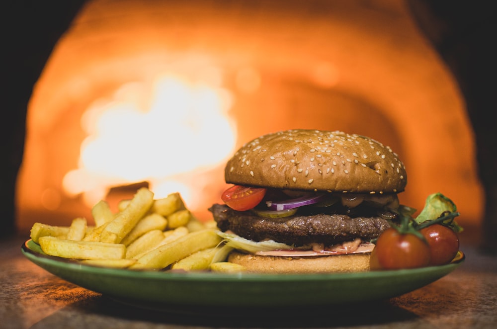 burger with fries on green plate