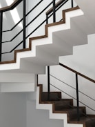 white concrete staircase with black metal railings