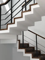 white concrete staircase with black metal railings