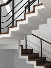 white concrete staircase with black metal railings
