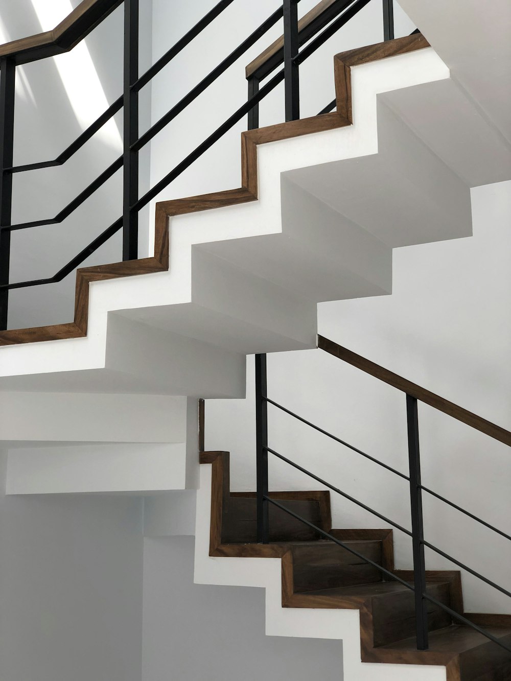 white concrete staircase with black metal railings