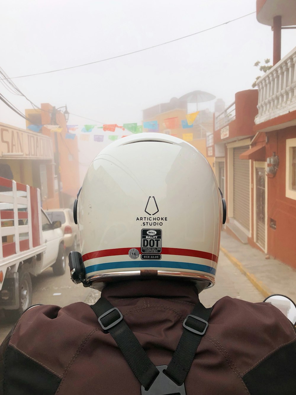 white and red helmet on white plastic chair