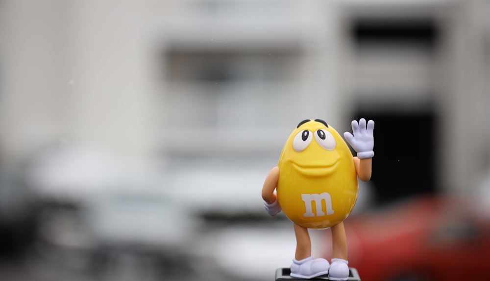 yellow m ms figurine