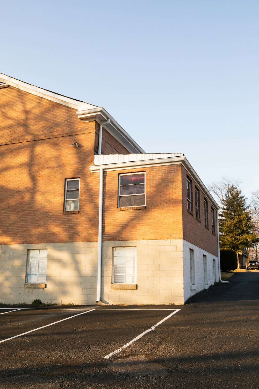 brown concrete building near green trees during daytime