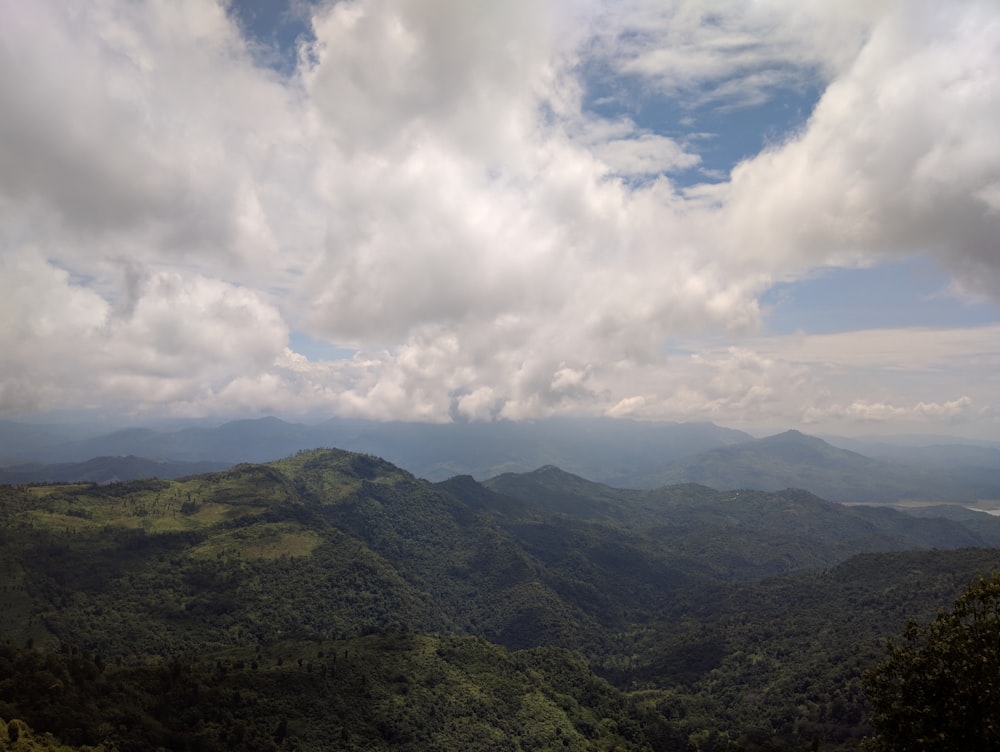 green mountains under white clouds during daytime