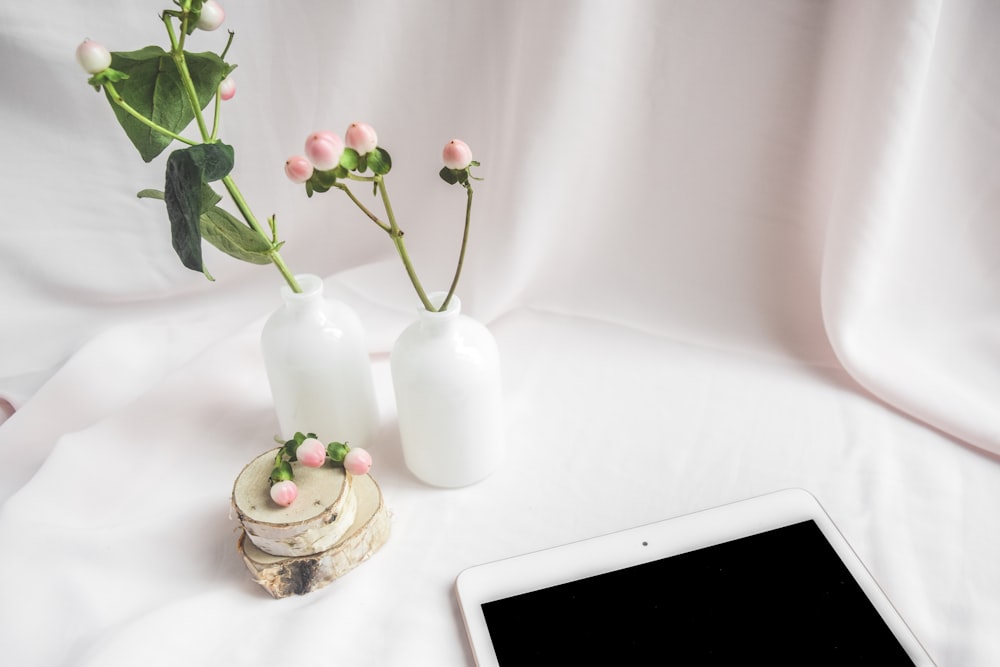 white ceramic vase with red roses