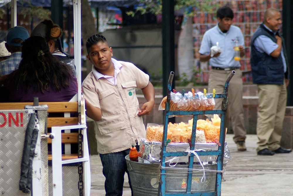 man in white button up shirt standing beside woman in blue denim jeans