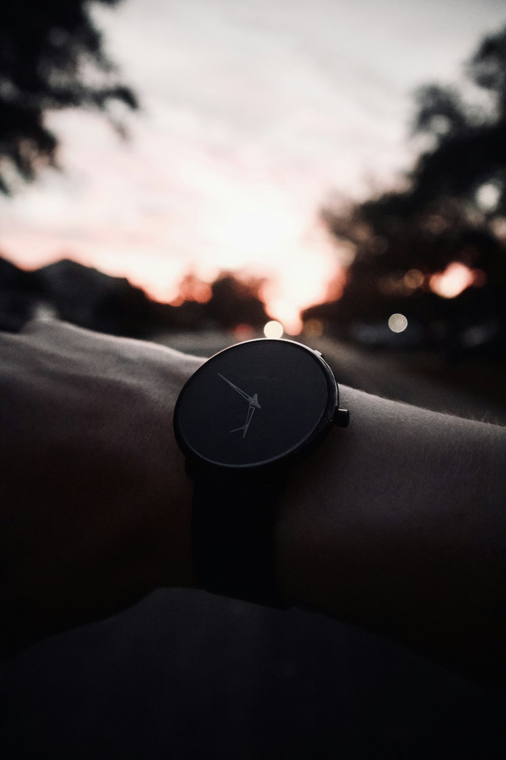 person wearing black analog watch