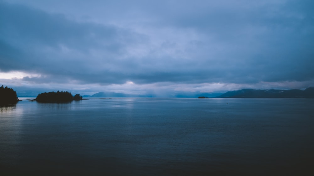 body of water under cloudy sky during daytime