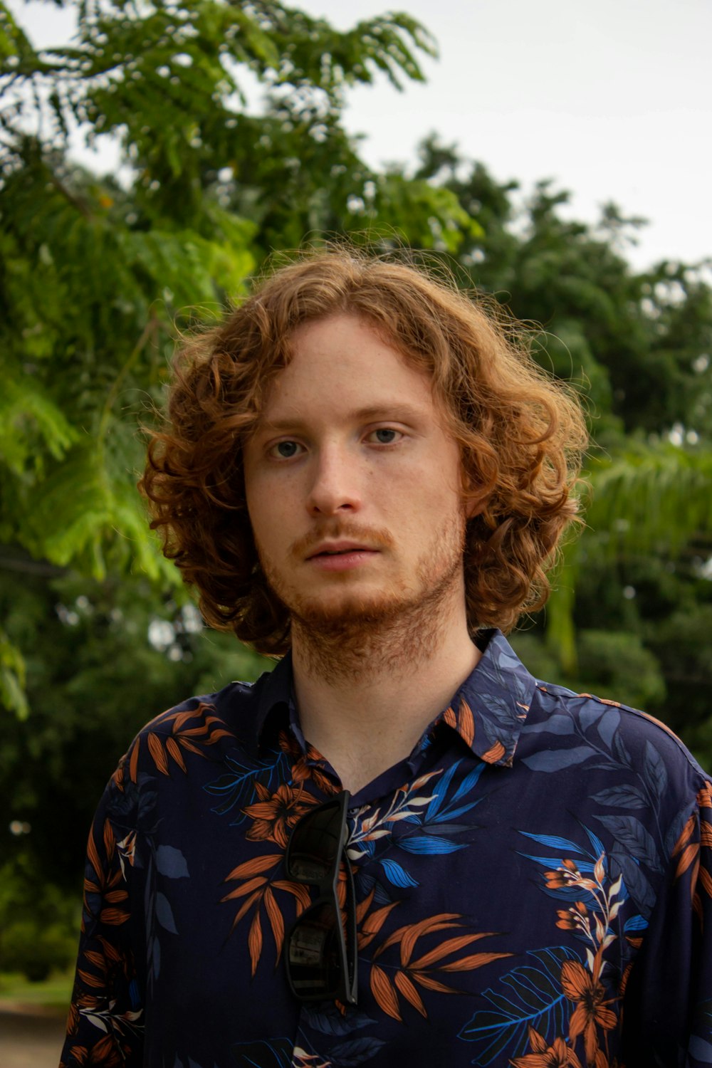 man in blue and white floral button up shirt