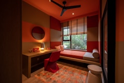 brown wooden table and chairs near window