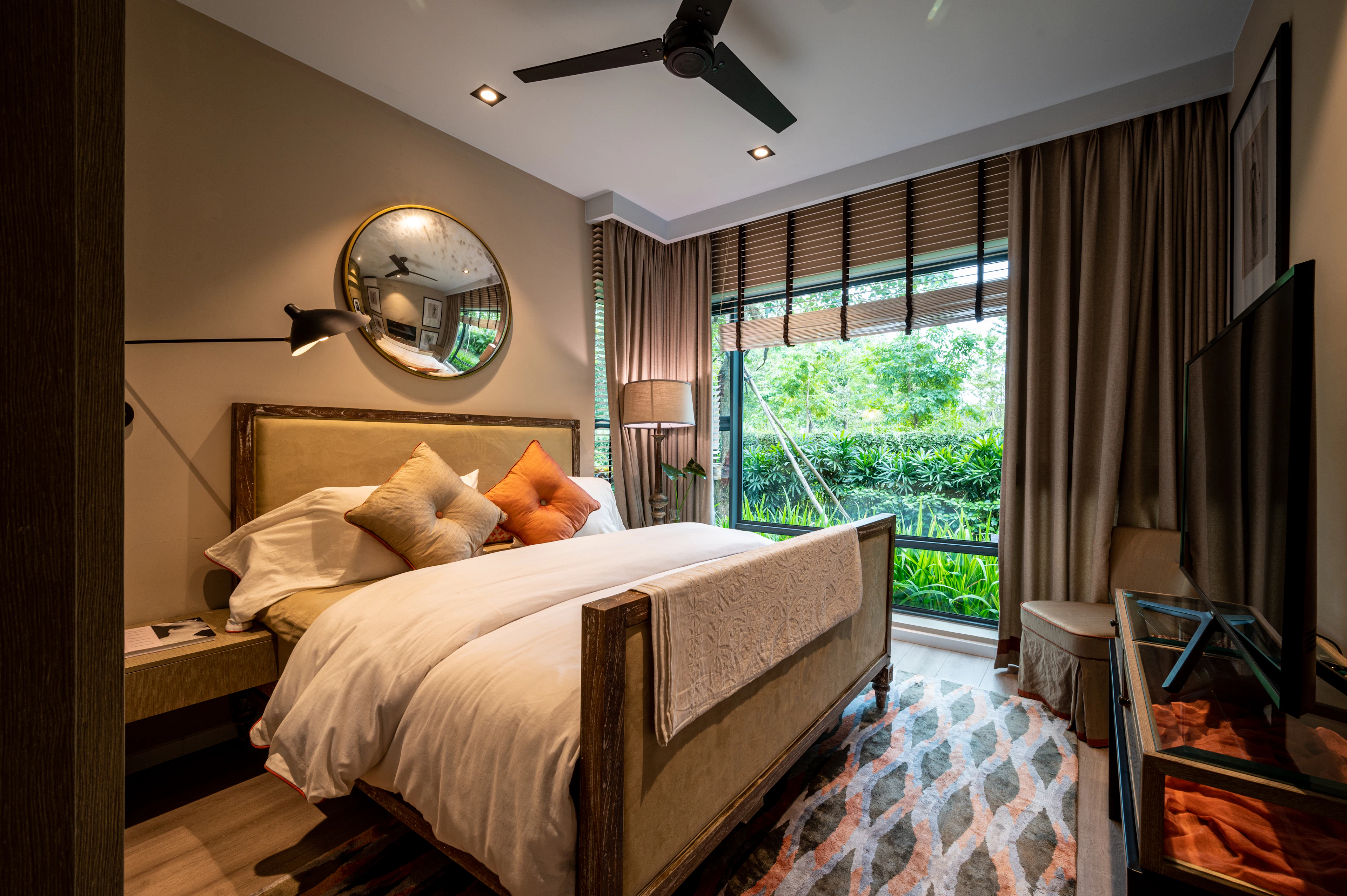 Bedroom with a round mirror and a patterned rug