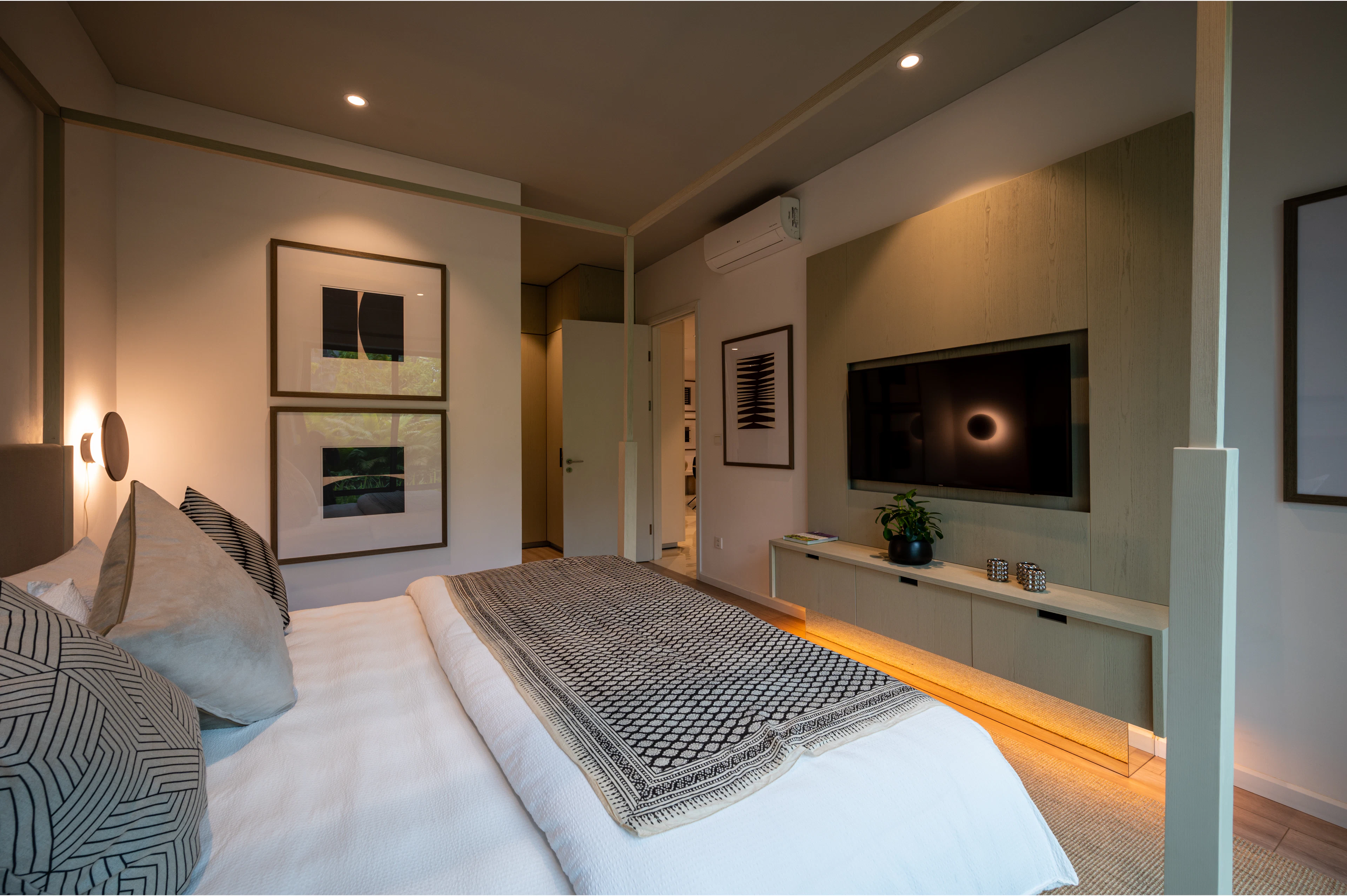 Bedroom with a large bed and a wall-mounted TV