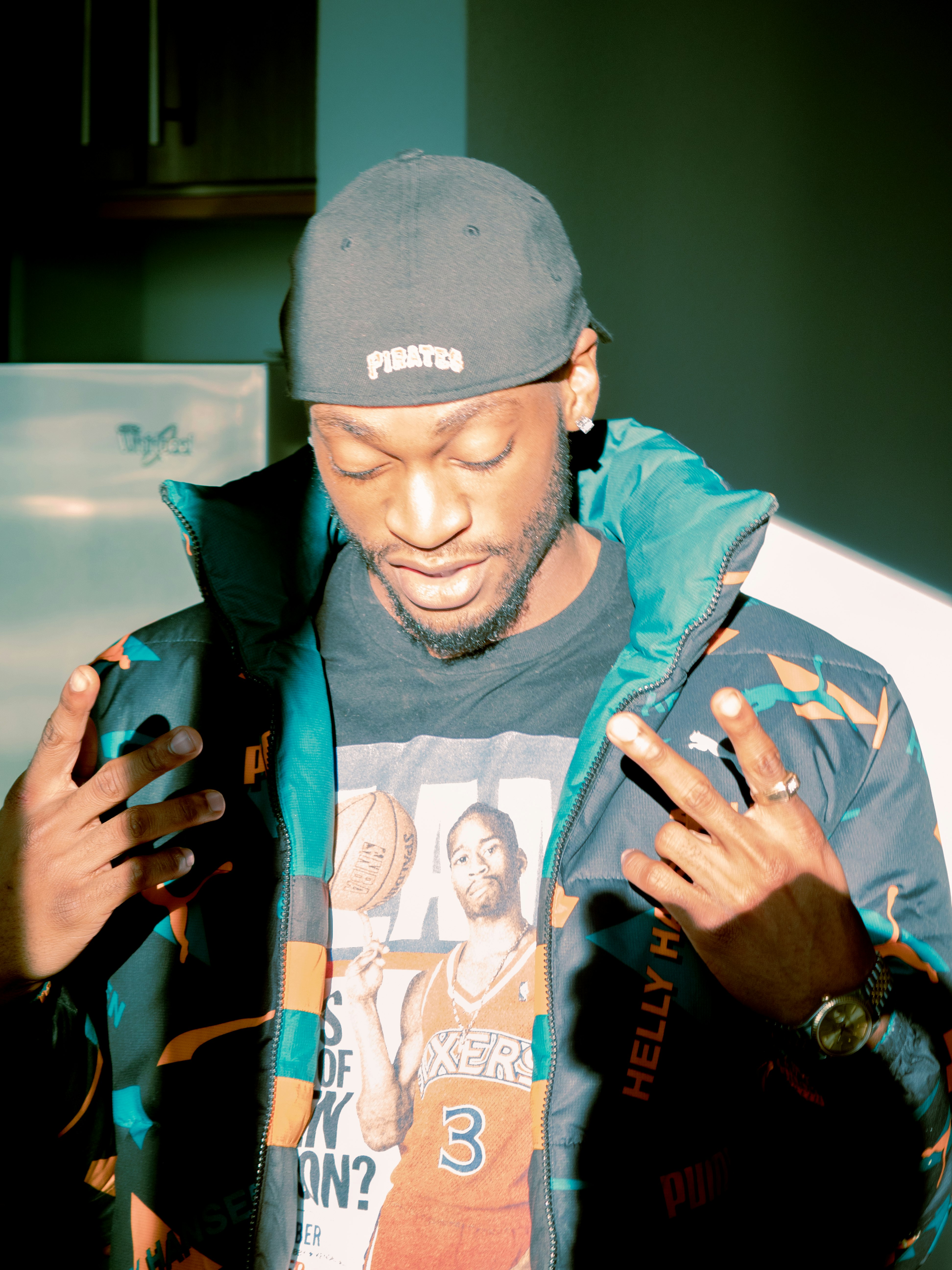 man in blue and white zip up jacket wearing black cap