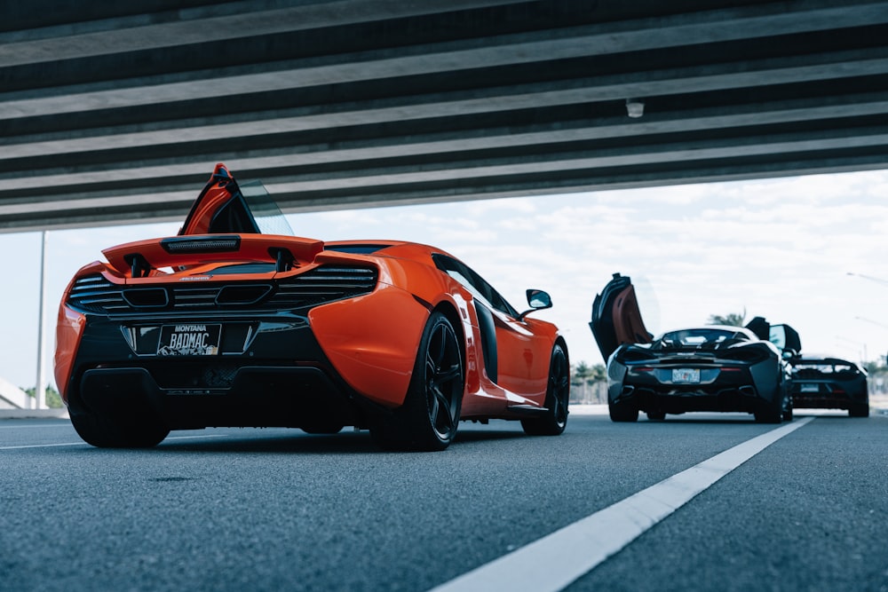 orange lamborghini aventador on gray asphalt road during daytime