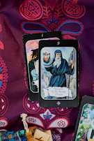 A vintage Marseille tarot deck arranged intricately on a deep purple velvet cloth.