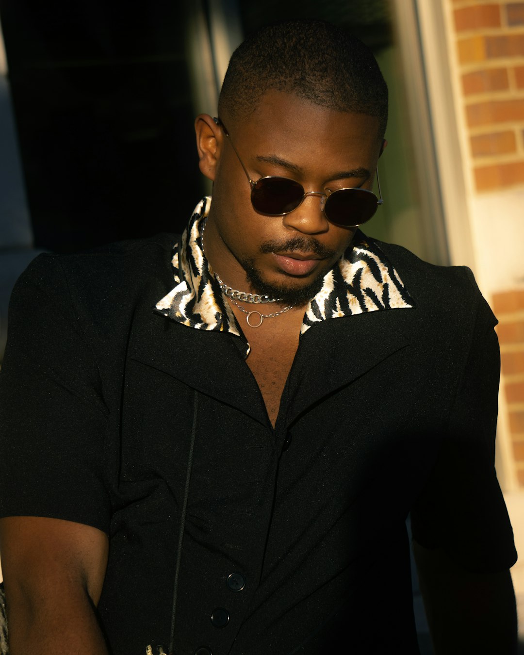 man in black button up shirt wearing sunglasses