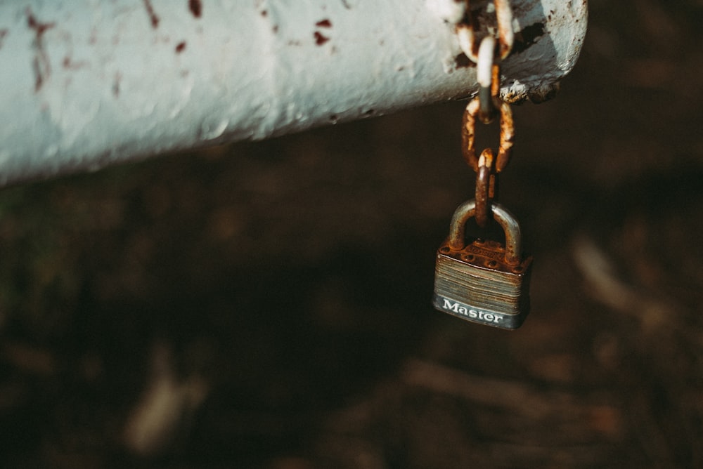 brown padlock on white metal bar