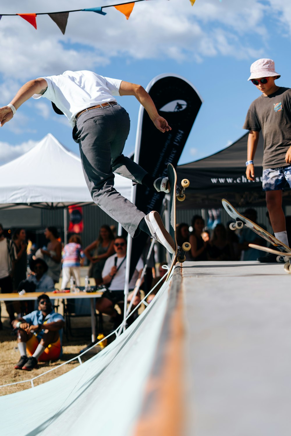 man in white shirt and black pants riding skateboard